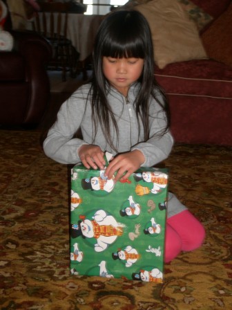 Kasen opening an early Christmas present